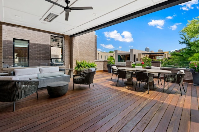 wooden deck featuring ceiling fan and an outdoor hangout area