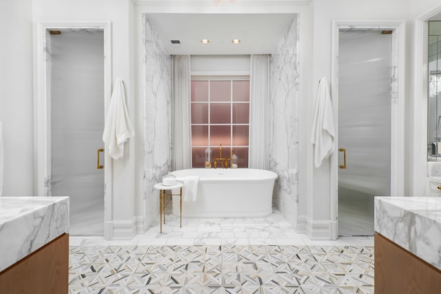 bathroom with tile floors, a bathtub, and vanity