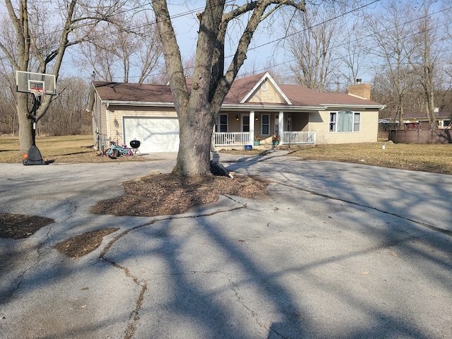 ranch-style house with a porch and a garage