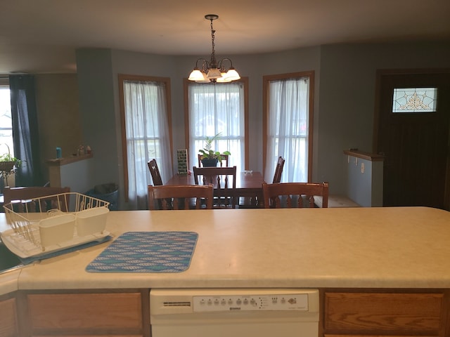 kitchen with a chandelier, hanging light fixtures, and dishwasher