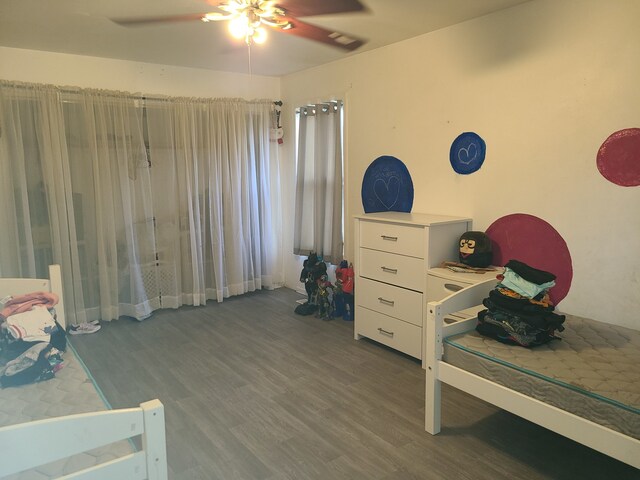 bedroom featuring ceiling fan and dark hardwood / wood-style flooring