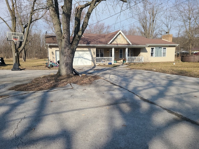 ranch-style home with covered porch and a garage