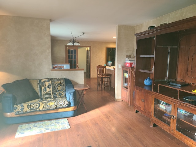 living room featuring hardwood / wood-style floors and a notable chandelier