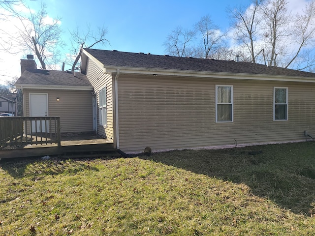 view of home's exterior featuring a deck and a lawn