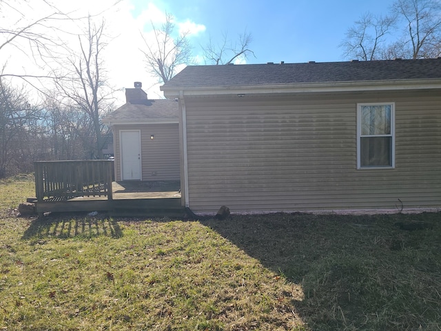 view of home's exterior featuring a yard and a wooden deck