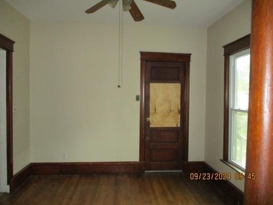 unfurnished room with ceiling fan and dark wood-type flooring