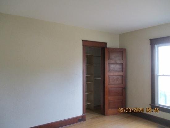 unfurnished bedroom featuring light hardwood / wood-style floors and multiple windows