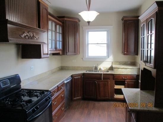 kitchen with pendant lighting, black range with gas stovetop, sink, stainless steel dishwasher, and dark hardwood / wood-style flooring