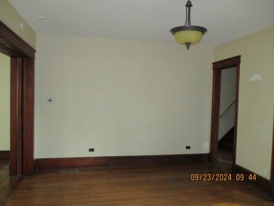 empty room with dark hardwood / wood-style flooring