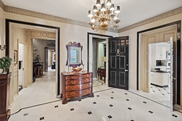 tiled foyer featuring an inviting chandelier