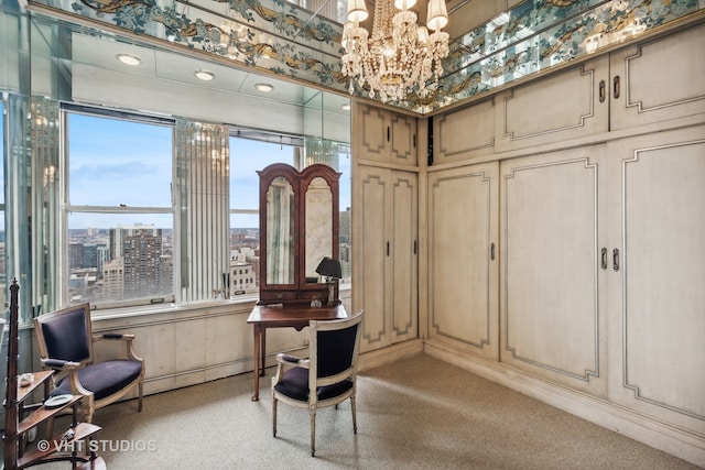 office space with a chandelier and light colored carpet