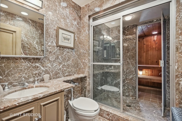 bathroom featuring vanity, tile flooring, toilet, and walk in shower