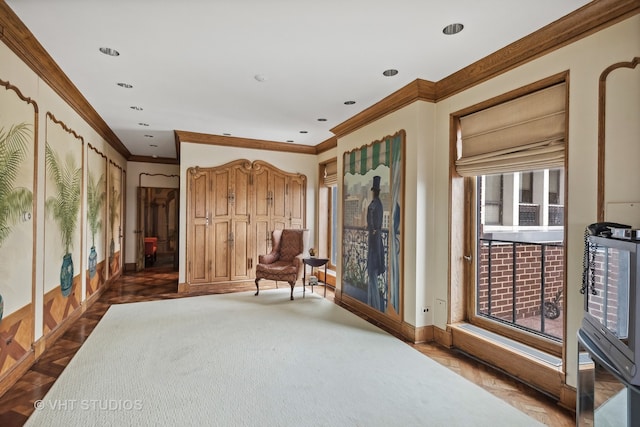 sitting room with dark parquet floors and ornamental molding