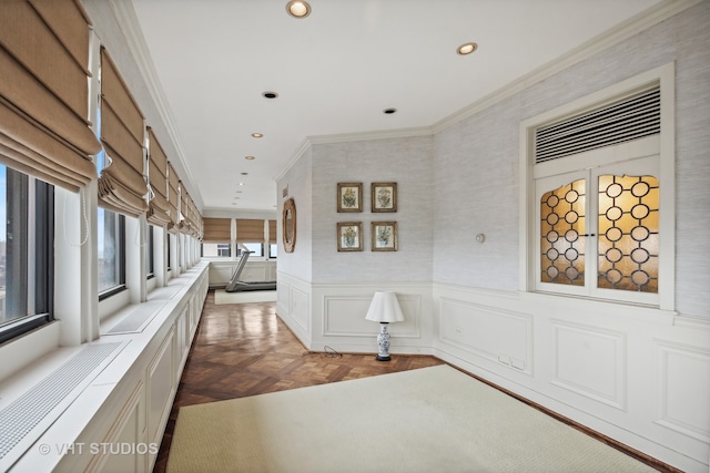 corridor with dark parquet flooring and ornamental molding