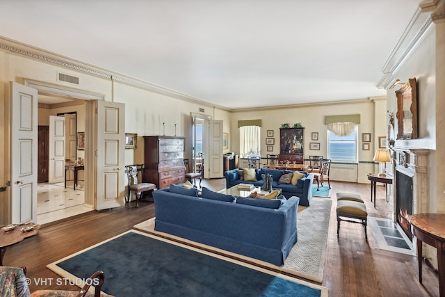 living room featuring dark wood-type flooring and ornamental molding