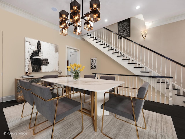 dining space with hardwood / wood-style flooring, a chandelier, and ornamental molding