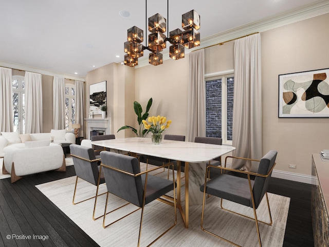 dining room with hardwood / wood-style flooring, an inviting chandelier, and ornamental molding