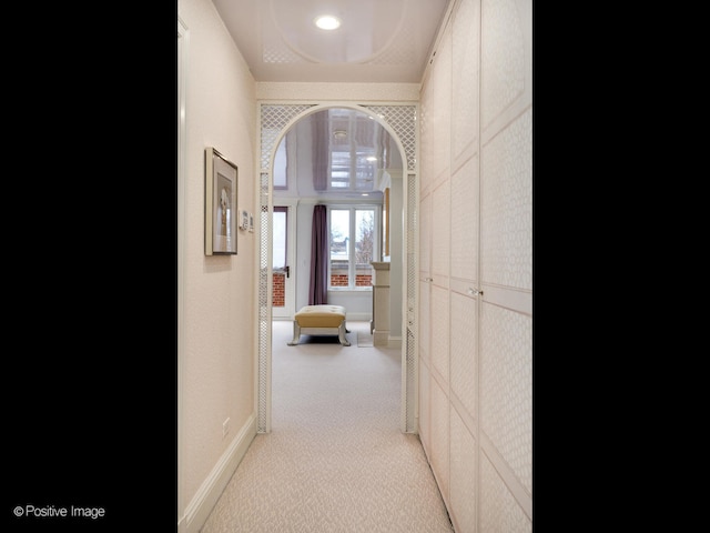 hallway featuring light carpet