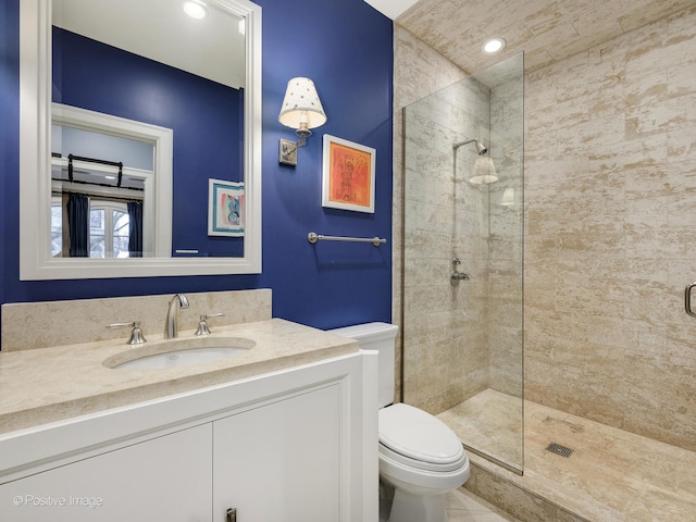 bathroom featuring tile patterned floors, an enclosed shower, vanity, and toilet