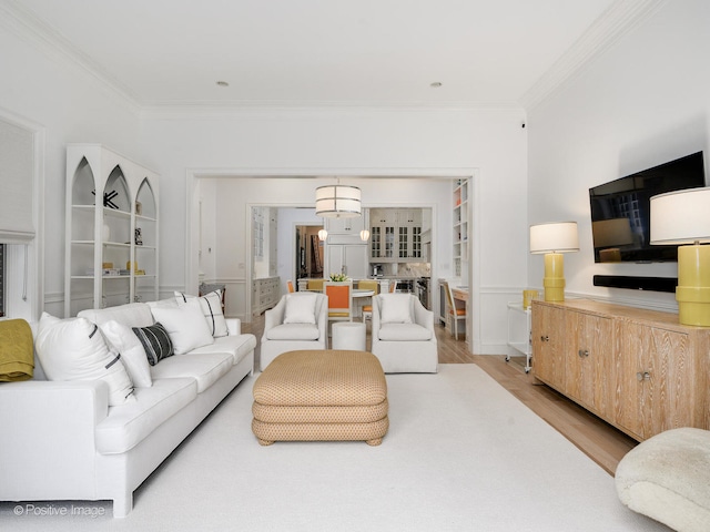 living room featuring wood-type flooring and ornamental molding