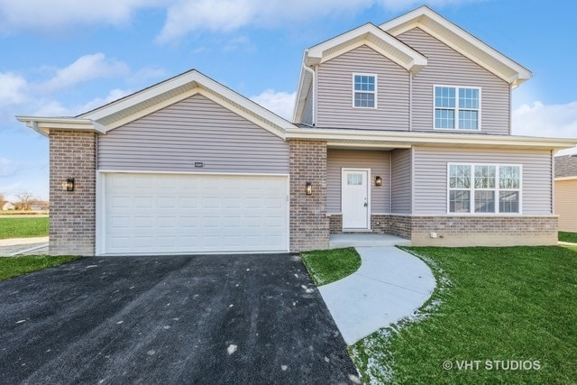 view of front of home featuring a front lawn and a garage