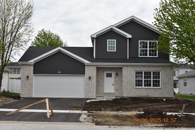 traditional home with a garage and brick siding