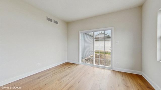 kitchen with a kitchen island, appliances with stainless steel finishes, a sink, light countertops, and light wood finished floors