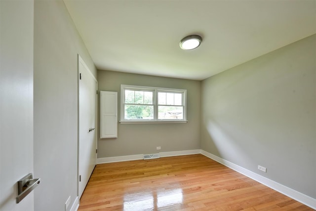 unfurnished room with light wood-type flooring