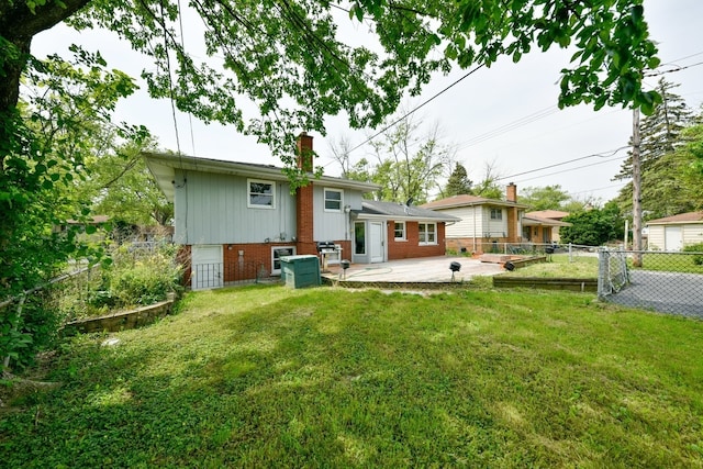 rear view of property with a lawn and a patio area