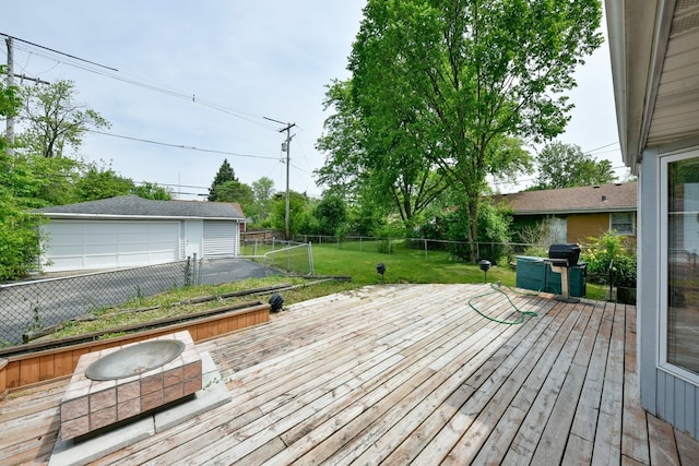 wooden deck featuring area for grilling, a yard, and a garage