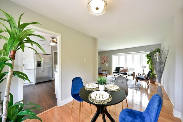 dining area featuring ceiling fan and light wood-type flooring