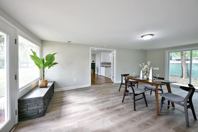 dining area with plenty of natural light and light wood-type flooring