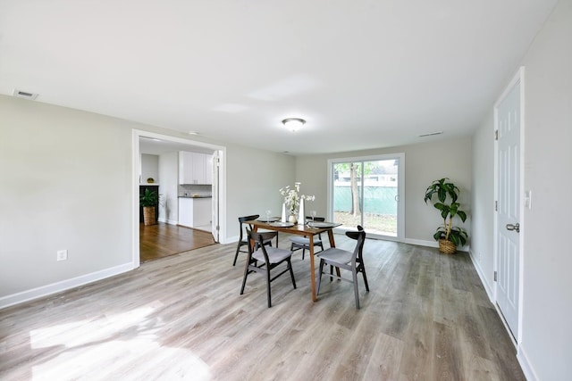 dining space with light hardwood / wood-style floors