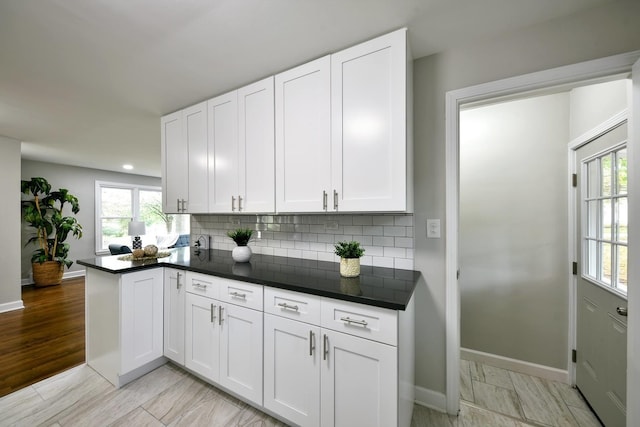 kitchen with light hardwood / wood-style flooring and white cabinets