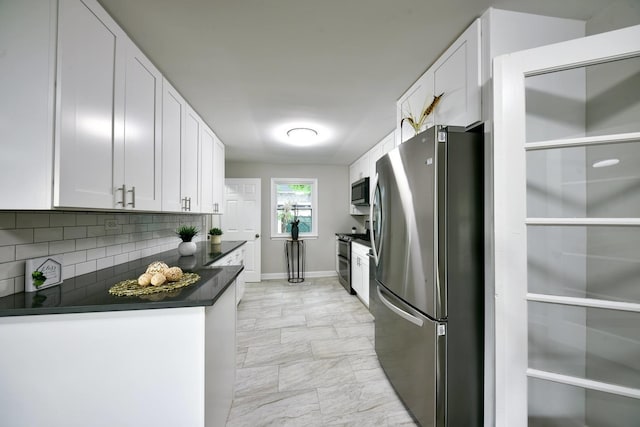 kitchen featuring stainless steel appliances, backsplash, white cabinetry, and light tile floors