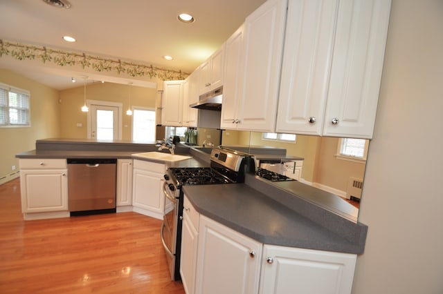 kitchen featuring light hardwood / wood-style flooring, stainless steel appliances, white cabinets, kitchen peninsula, and sink