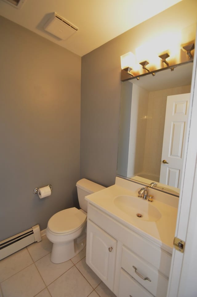 bathroom with tile flooring, a baseboard radiator, vanity, and toilet