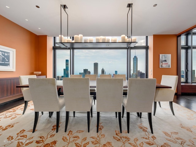 dining area with an inviting chandelier, light wood-type flooring, and a wealth of natural light