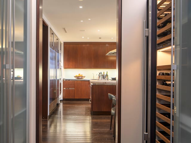 kitchen with a kitchen breakfast bar, a kitchen island, stainless steel built in refrigerator, oven, and dark hardwood / wood-style floors