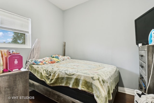 bedroom with dark hardwood / wood-style flooring