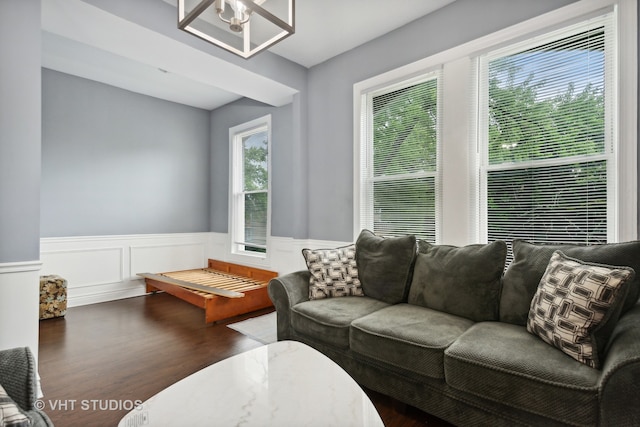 living room featuring ceiling fan and dark wood-type flooring