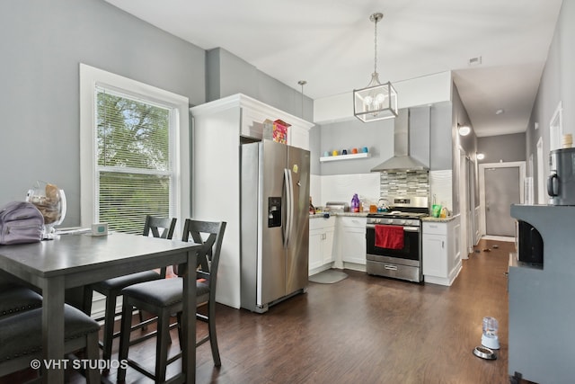 kitchen featuring tasteful backsplash, dark wood-type flooring, stainless steel appliances, exhaust hood, and decorative light fixtures