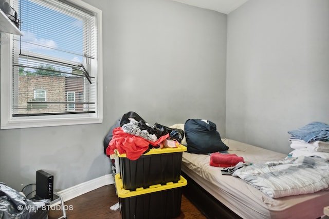 bedroom with dark wood-type flooring