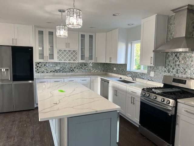 kitchen featuring tasteful backsplash, stainless steel appliances, dark hardwood / wood-style flooring, white cabinetry, and wall chimney exhaust hood