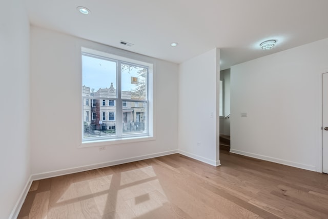 spare room with wood-type flooring