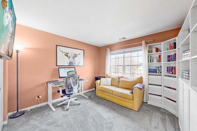 office area with carpet floors, baseboards, and visible vents