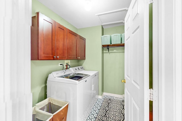 laundry area featuring washing machine and clothes dryer, cabinet space, attic access, baseboards, and tile patterned floors