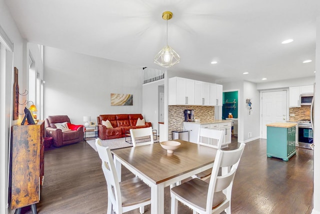 dining room with baseboards, dark wood-type flooring, and recessed lighting