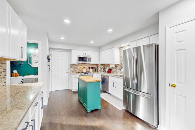 kitchen featuring white cabinets, dark wood finished floors, butcher block countertops, stainless steel appliances, and recessed lighting