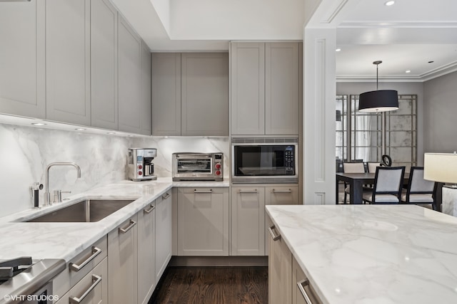 kitchen featuring decorative light fixtures, light stone counters, black microwave, and dark hardwood / wood-style floors